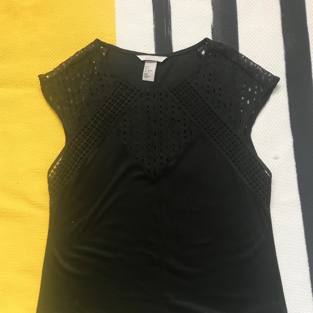 Black top with unique stitching above breast area